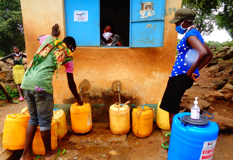 Water collection at a kiosk in rural Kenya during the COVID19 pandemic. Credit: Mary Musenya Sammy