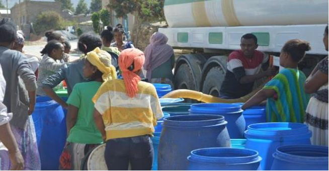 Women queuing to get their share of water rationed by the utility (taken during the dry season, 2019) 