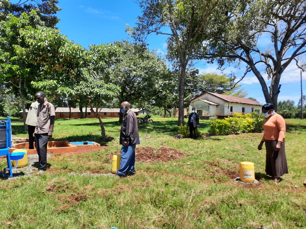 Water users take social distancing measures while queuing for water from a standpipe in Kenya (Photo courtesy of Water Mission)