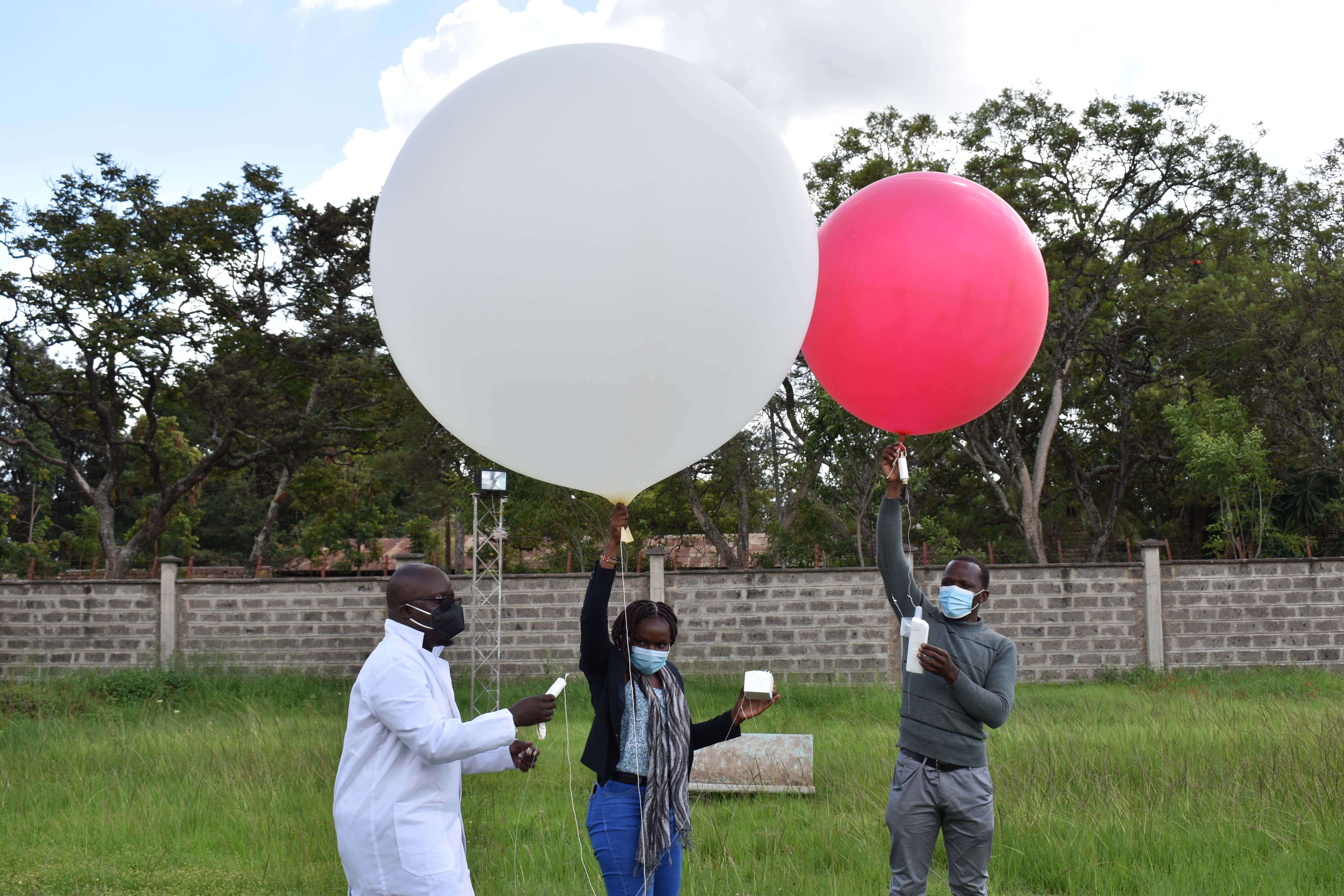 Students from the University of Nairobi and a researcher from Kenya Meteorological Department prepare to launch weather balloons carrying radiosondes to measure wind speed and other atmospheric parameters as part of the RIFTJET campaign. Credit: Callum Munday